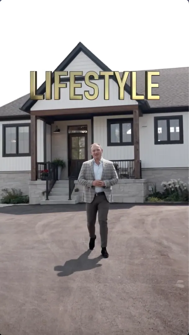 A man in a suit walks toward the camera in front of a modern house with "LIFESTYLE" written above the roof in large gold letters.